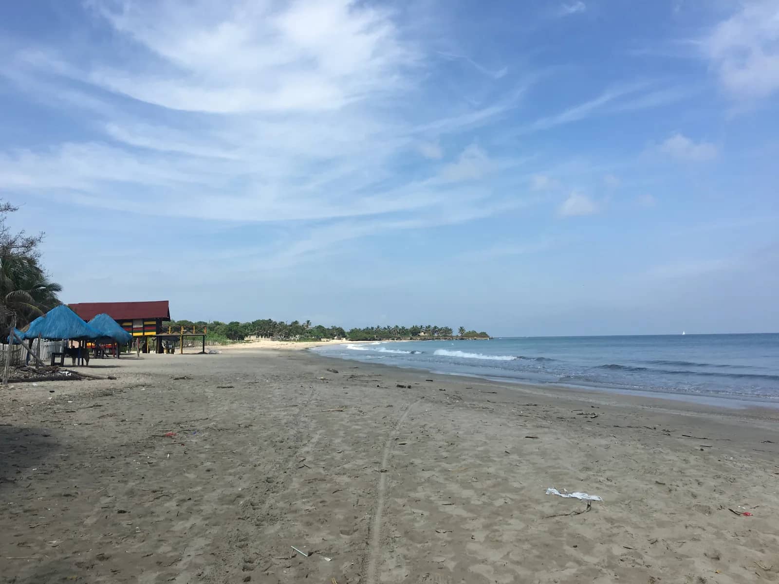 Beach on Colombia’s Caribbean coast with traditional huts, palm trees, and ocean
